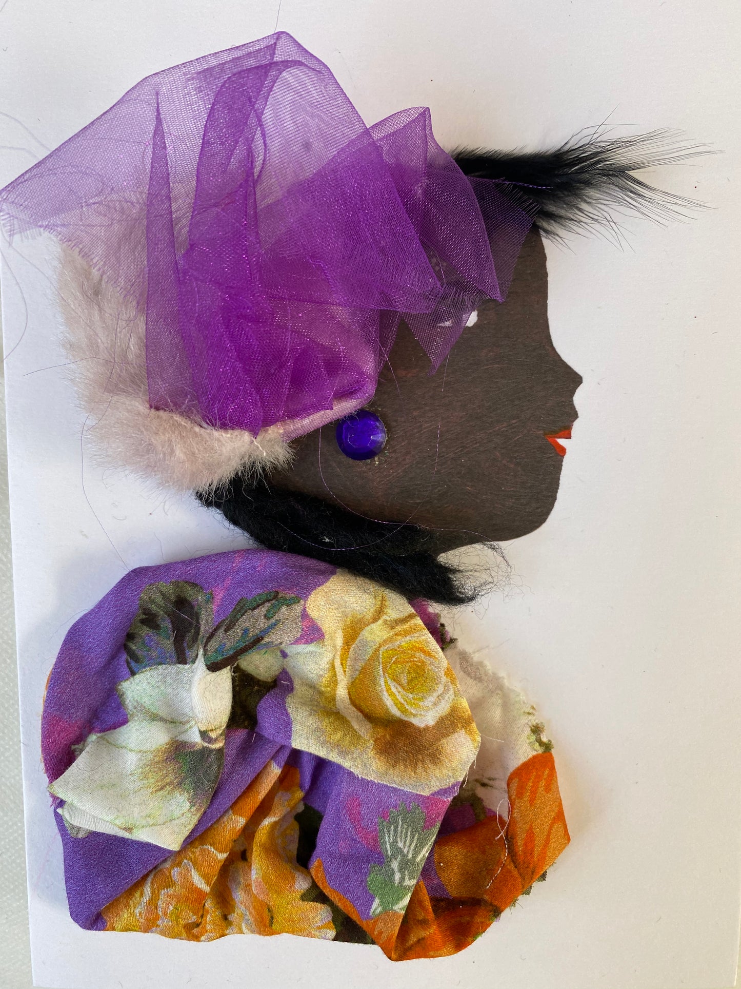 i designed this card of a woman who wears a furry hat with ravishing purple fabric coming out. She wears a beautiful purple floral blouse with deep purple earrings. 