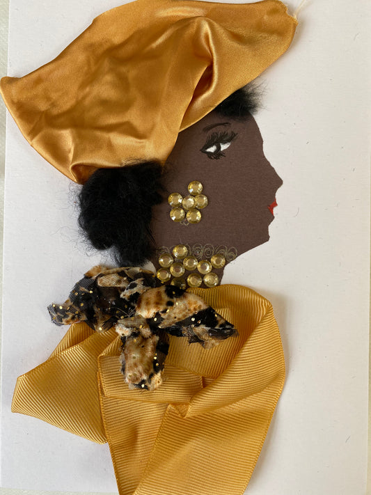 I designed this card of a woman named Doctor Goldhawk. She has a black skin tone and is wearing a luscious silk gold hat. She wears a beautiful bow around her neck with a silky gold blouse. She wears dazzling gold jewellery.