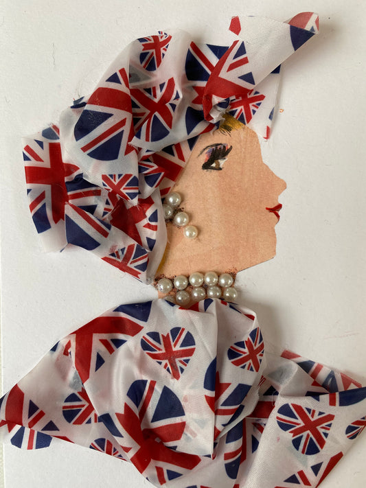 I designed this card of a woman who is wearing a hat with hearts that are the London flag. She wears a blouse that also has hearts with the London flag. She wears pearl jewellery. 