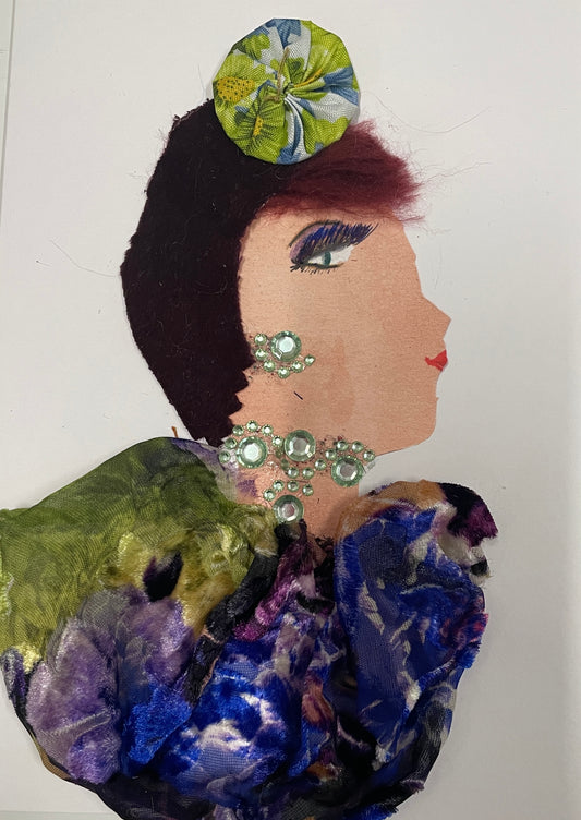 She is wearing her special lime green hat, pale green jewellery and a purple-green blouse. She has short red hair.