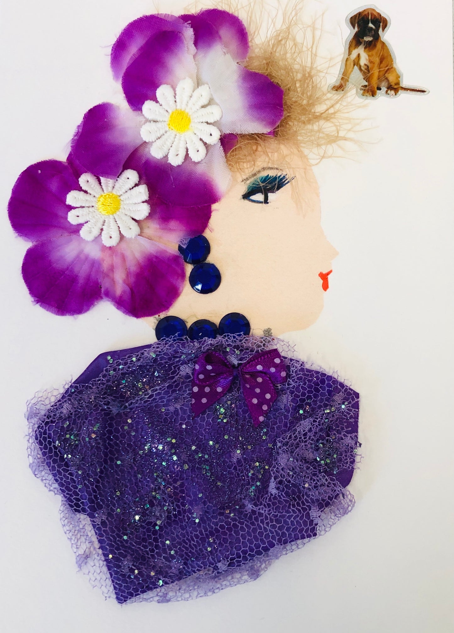 Kenton wears a glittery mesh blouse and two large purple flowers in her blonde string hair. In the top right corner, there is a small dog sticker. 