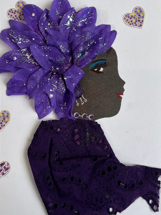 This card is called Jamie. She wears a purple eyelet blouse and a large purple flower in her hair. Surrounding her there is small purple hearts.