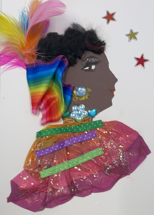 This card is called Rainbow Rally. She wears a rainbow tissue paper blouse with gold glitter on it. She wears a rainbow ribbon headscarf with rainbow feathers peaking out the top. Her hair is short, black and curly. To the right of her, there are three stars. 