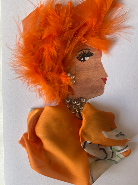 I designed this card of a woman named Charming Chelsea. She has a white skin tone and has an array of orange feathers in her hair. She wears a beautiful silk orange blouse. She wears white gem jewellery.