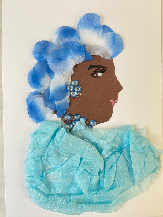 I designed this card of a woman named Bethany Blissful. She has a brown skin tone and wears a blue and white flower petal headwrap. She wears a cute blue blouse with matching blue jewellery. 